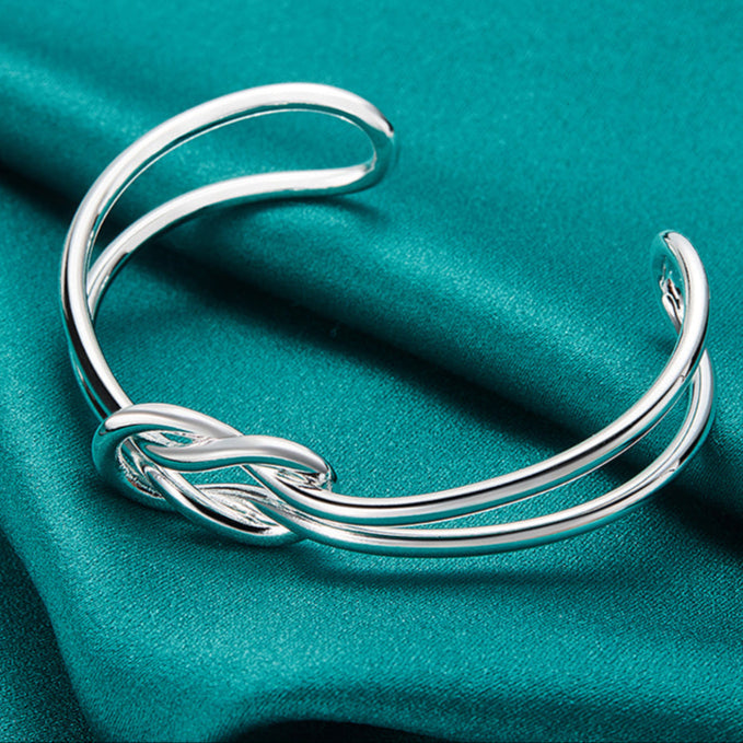 Bracelete Entrelace Verzano® em prata esterlina 925, design geométrico entrelaçado, ajustável, unissex, elegante e sofisticado.